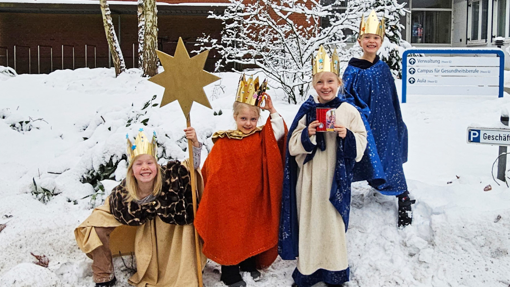 Sternsinger Kinder im Schnee vor dem Krankenhaus Reinbek